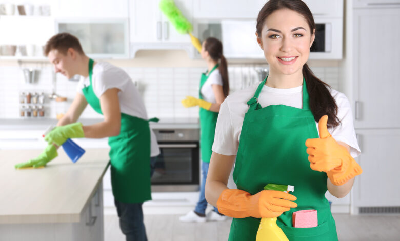 Young female cleaner at work in kitchen