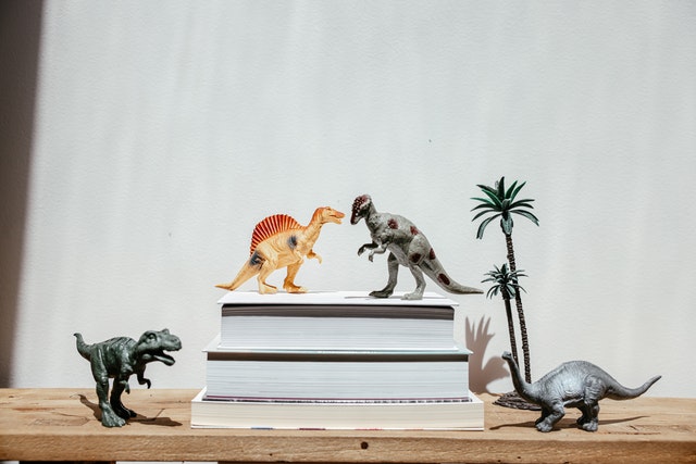 plastic-dinosaur-toys-on-wooden-table