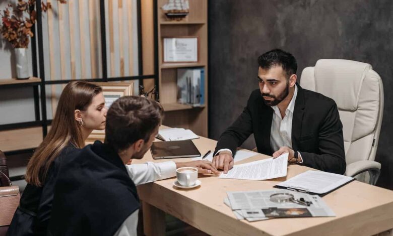 a-man-in-black-suit-talking-to-his-clients