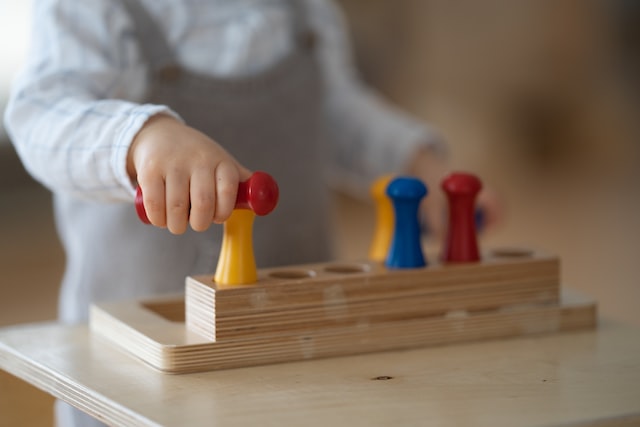 cute baby discovers and plays in a montessori nest