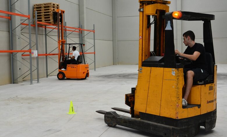 loader removes pallets on warehouse shelves